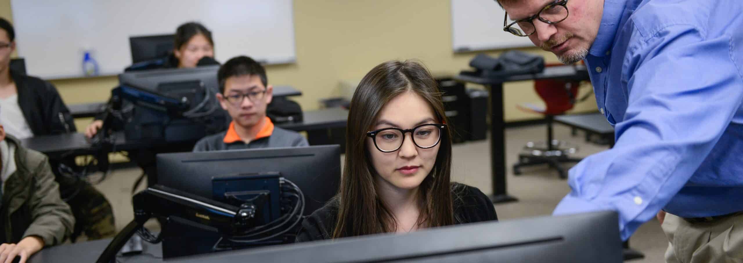 International students work in small groups in a classroom at the Intensive English program offices at NC State. Photo by Marc Hall