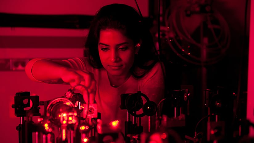 Student working with lasers in lab