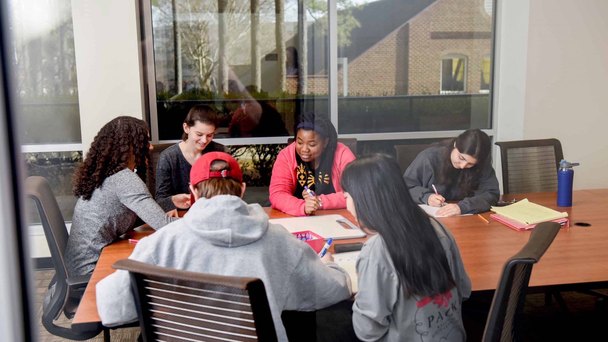 Students working in conference room in WISE Village offices in Lee Hall