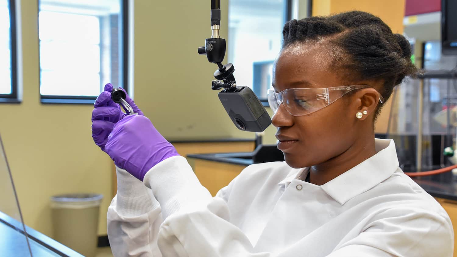 Teaching Assistant Lyniesha Wright during a test shoot of the organic chemistry virtual reality labs. The placement of the GoPro Fusion 360° camera gives the experience a first-person point of view.