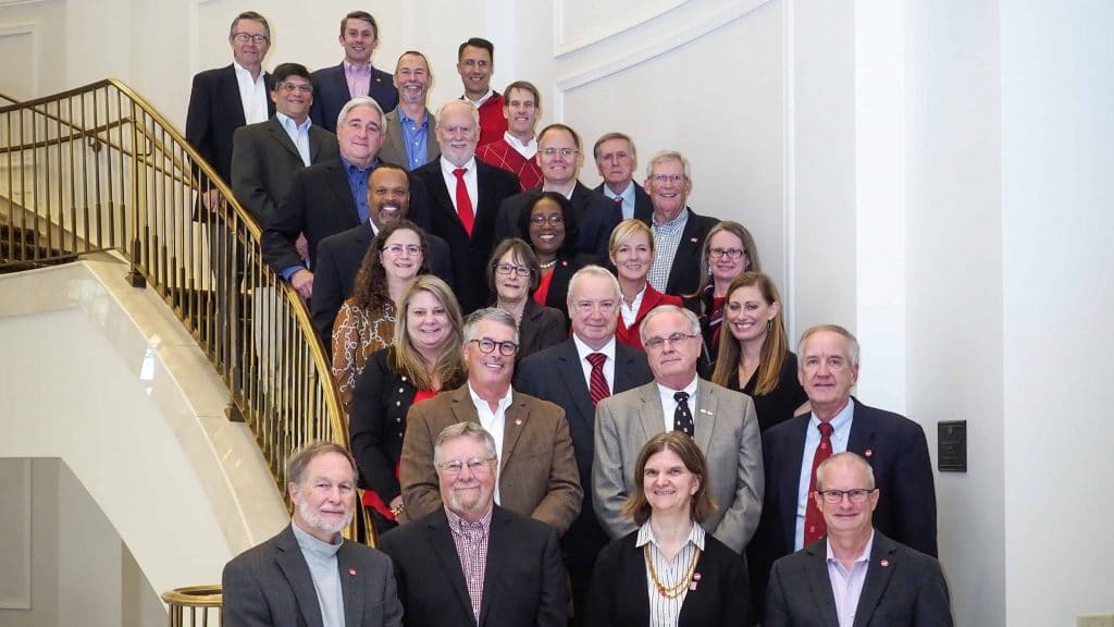 The members of the 2019-20 College of Sciences Foundation Board pose on a staircase in the Park Alumni Center