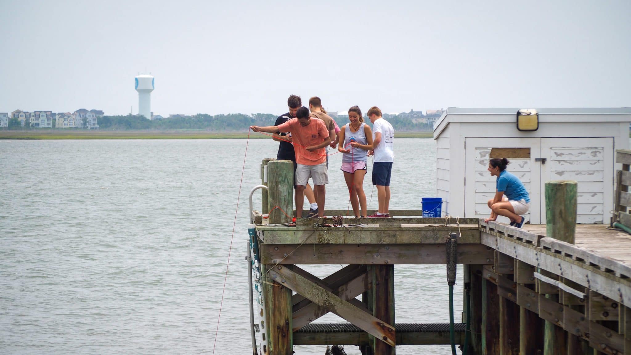 Students practice dredging for plankton off a pier at CMAST in Morehead City