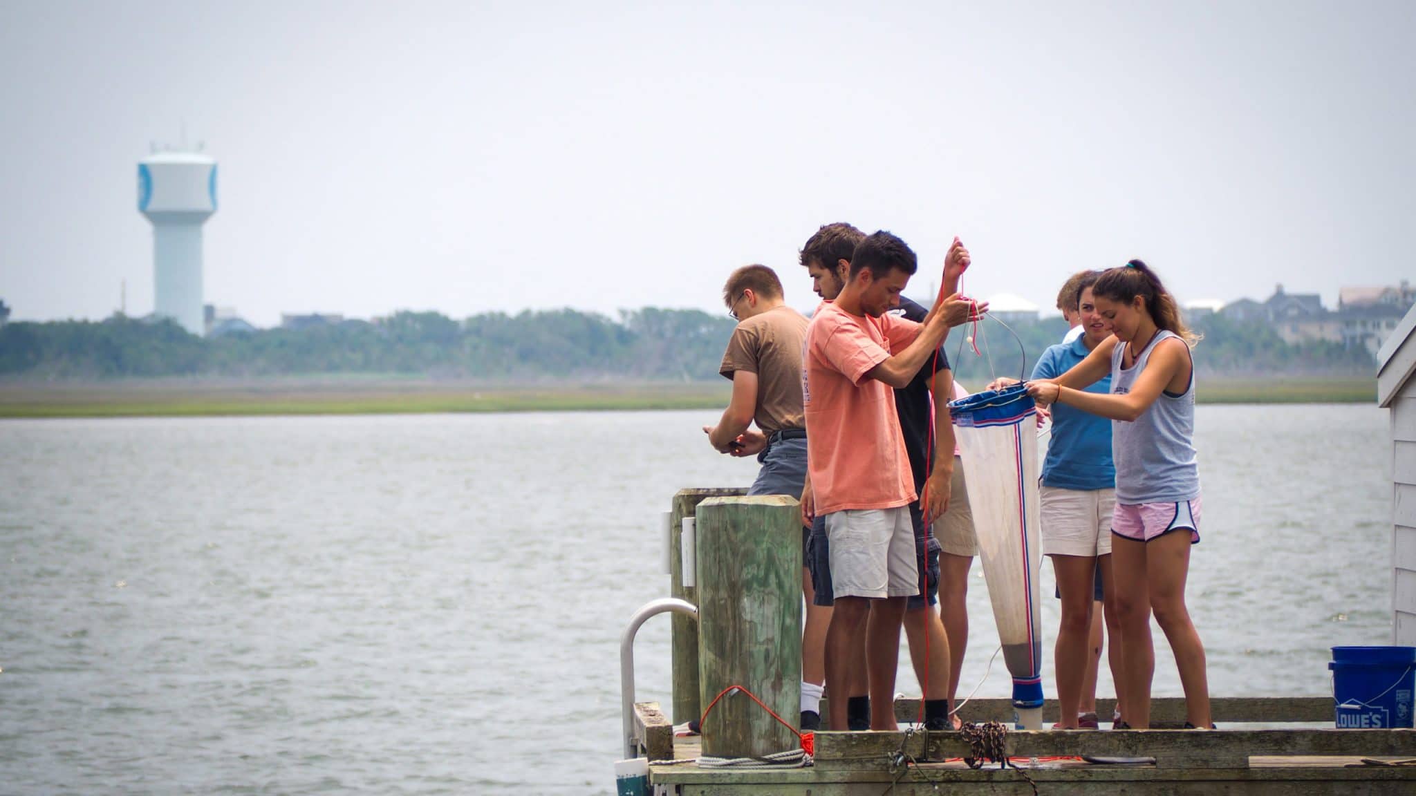 Students practice dredging for plankton off a pier at CMAST in Morehead City