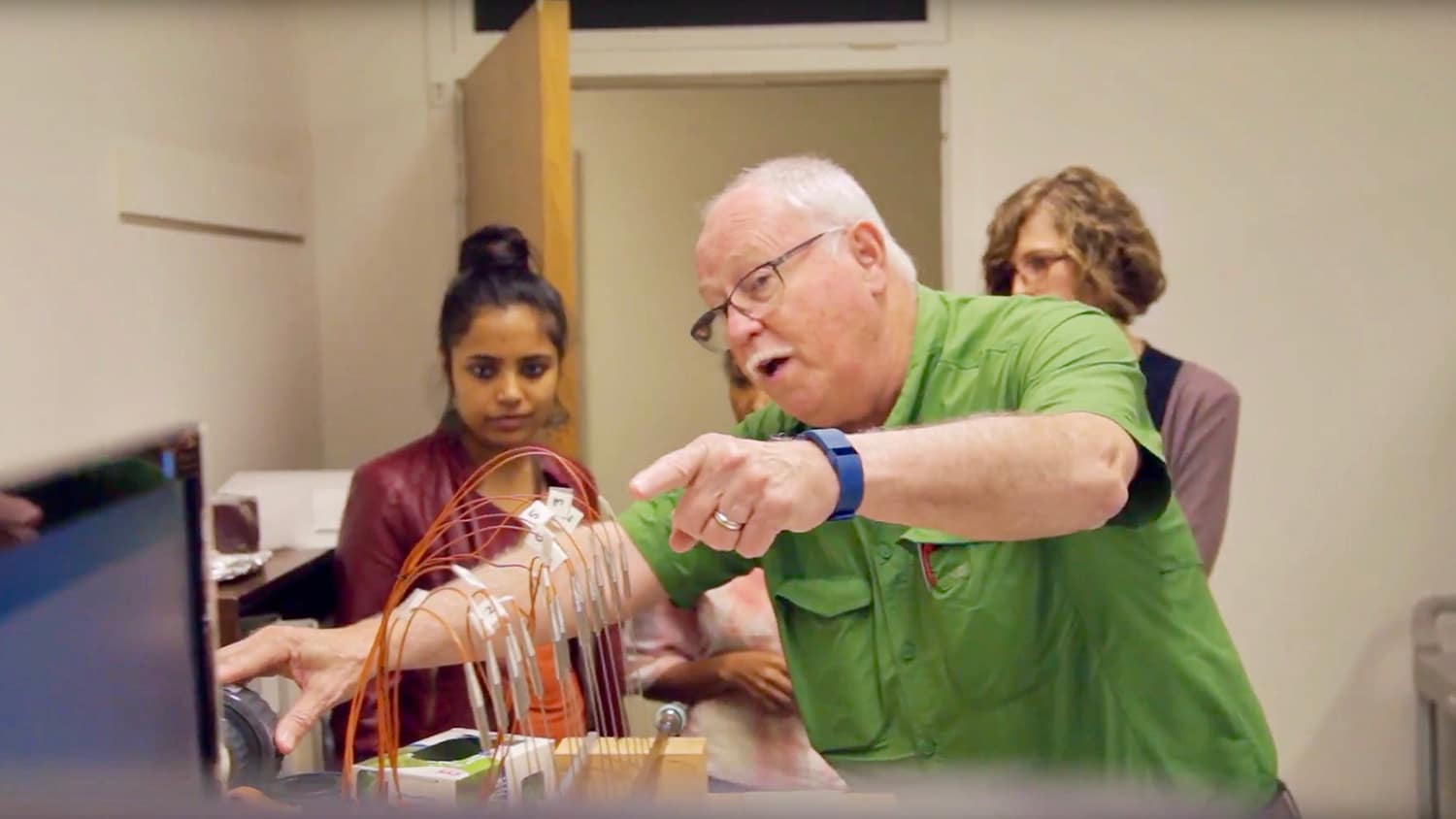Tom Banks demonstrates a mathematical experiment to students in his lab