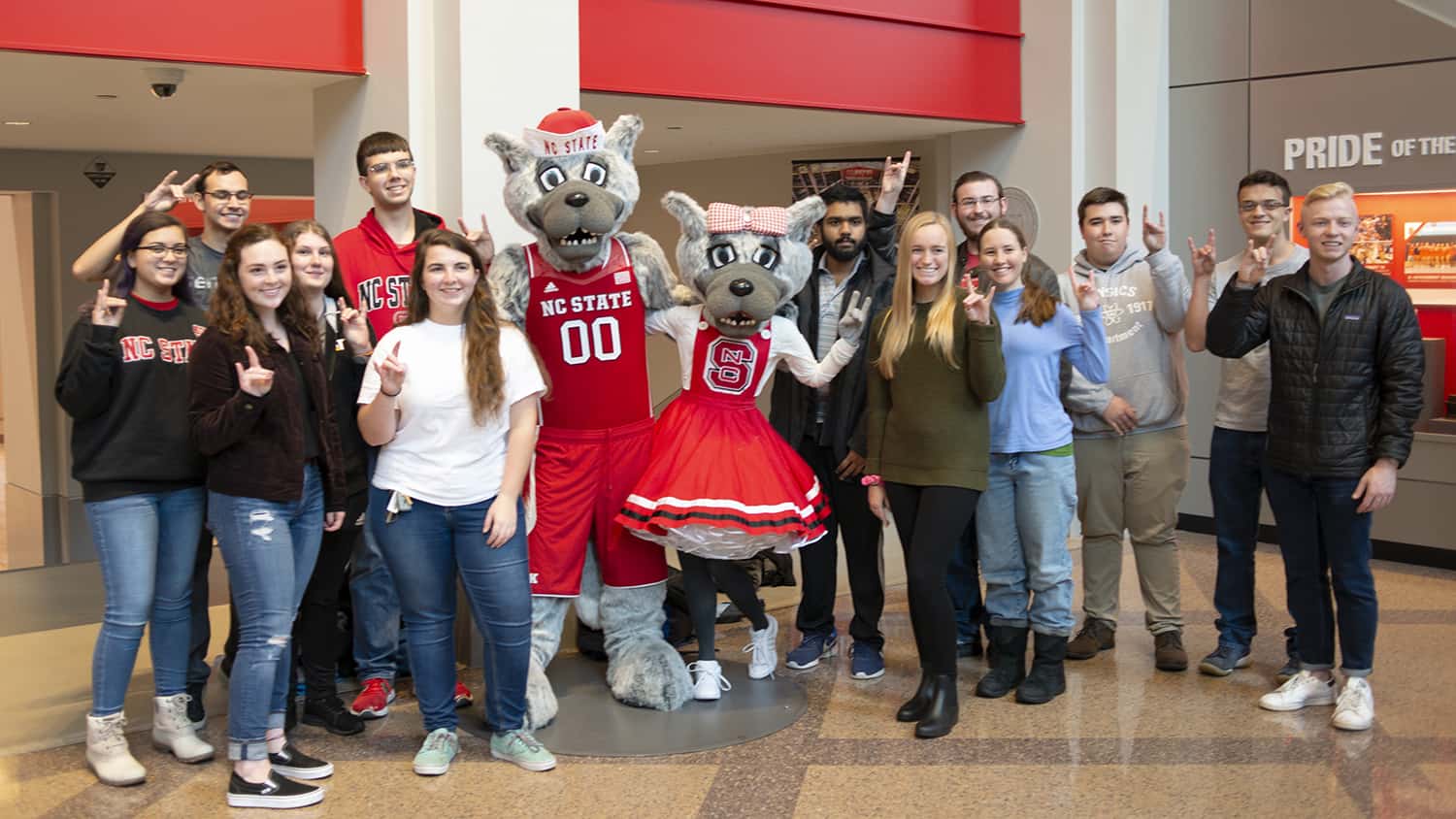 The Solomon Scholars pose with Mr. and Ms. Wuf in Reynolds Coliseum