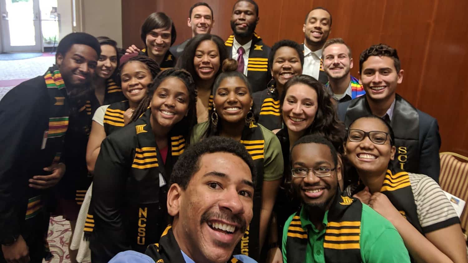 A group of diverse students pose for a selfie
