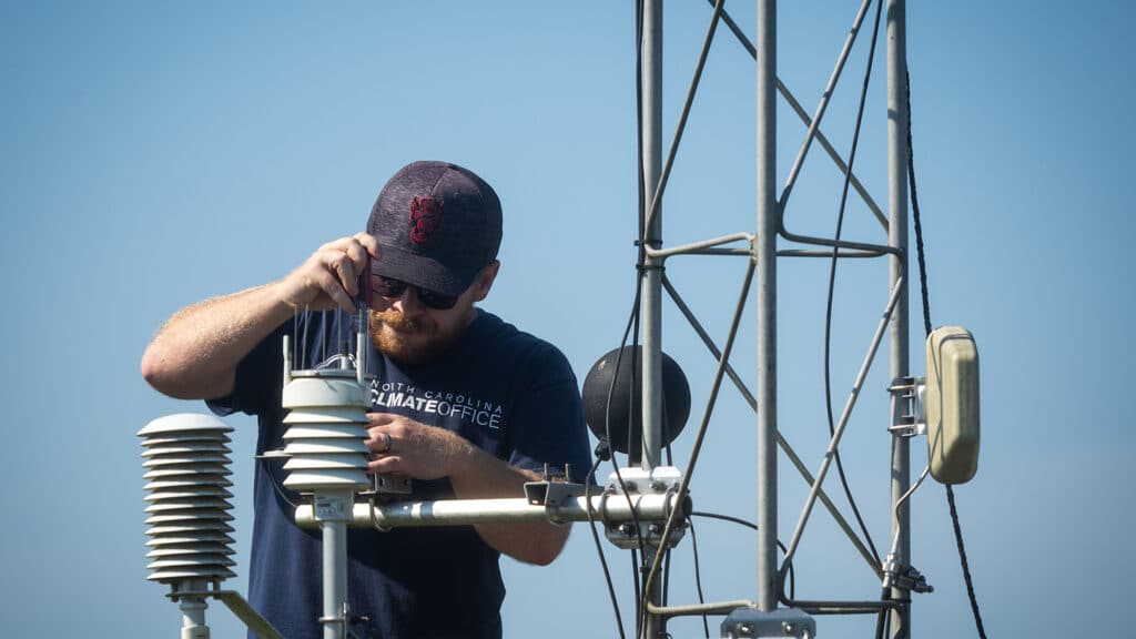 Instrumentation Technician Cam Baillie works to help service a weather station off Lake Wheeler Road. 