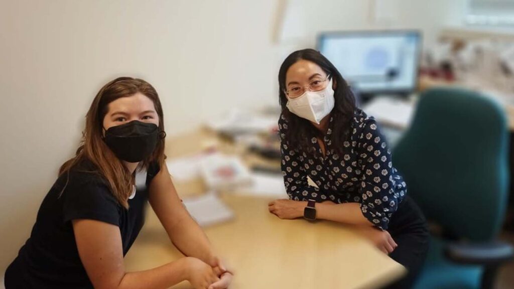 A Catalyst student poses with a professor.