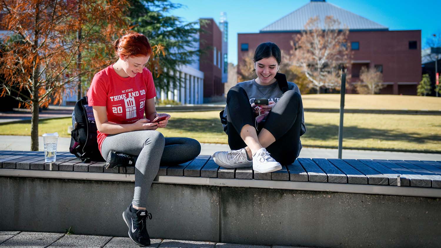 Students enjoy warm weather outside the Hunt Library on Centennial Campus.