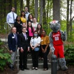 A group of students pose with Mr. Wuf