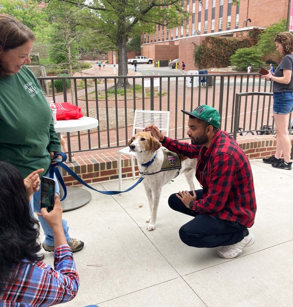 A student pets a dog.