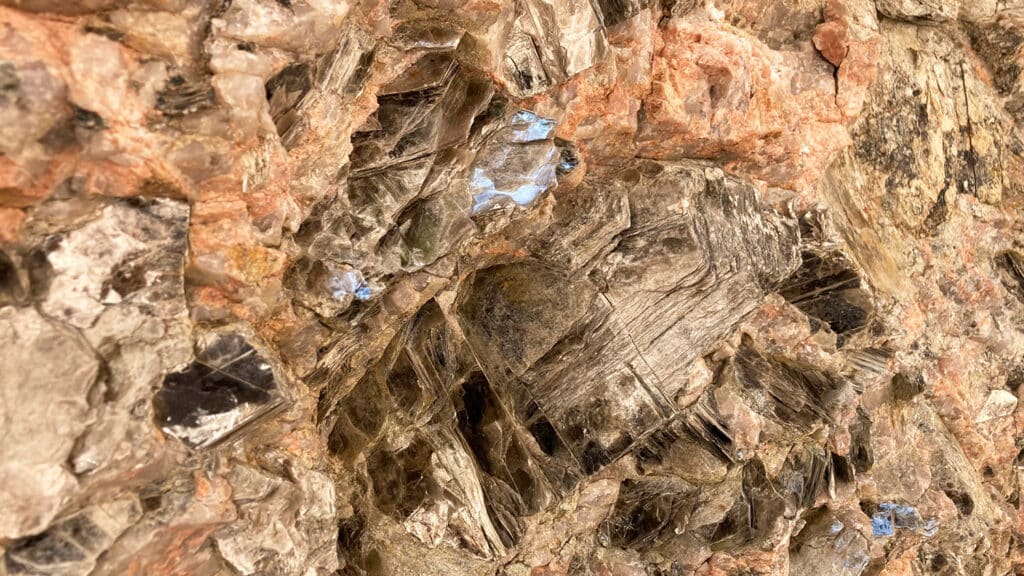 Exposed pegmatite with micas, feldspar and quartz.