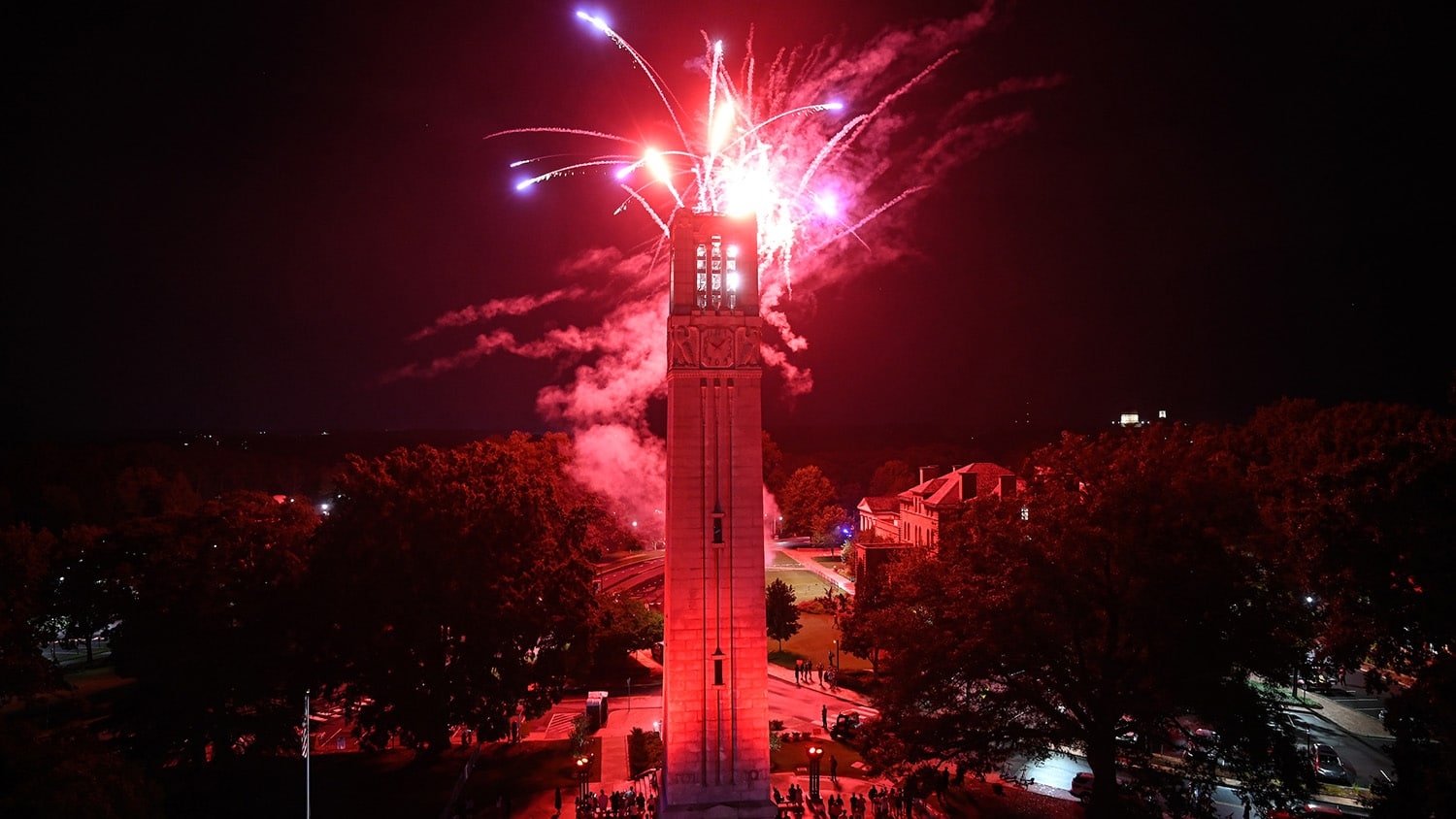 Red fireworks light up the sky above the Belltower as an explosive end to Packapalooza 2022.