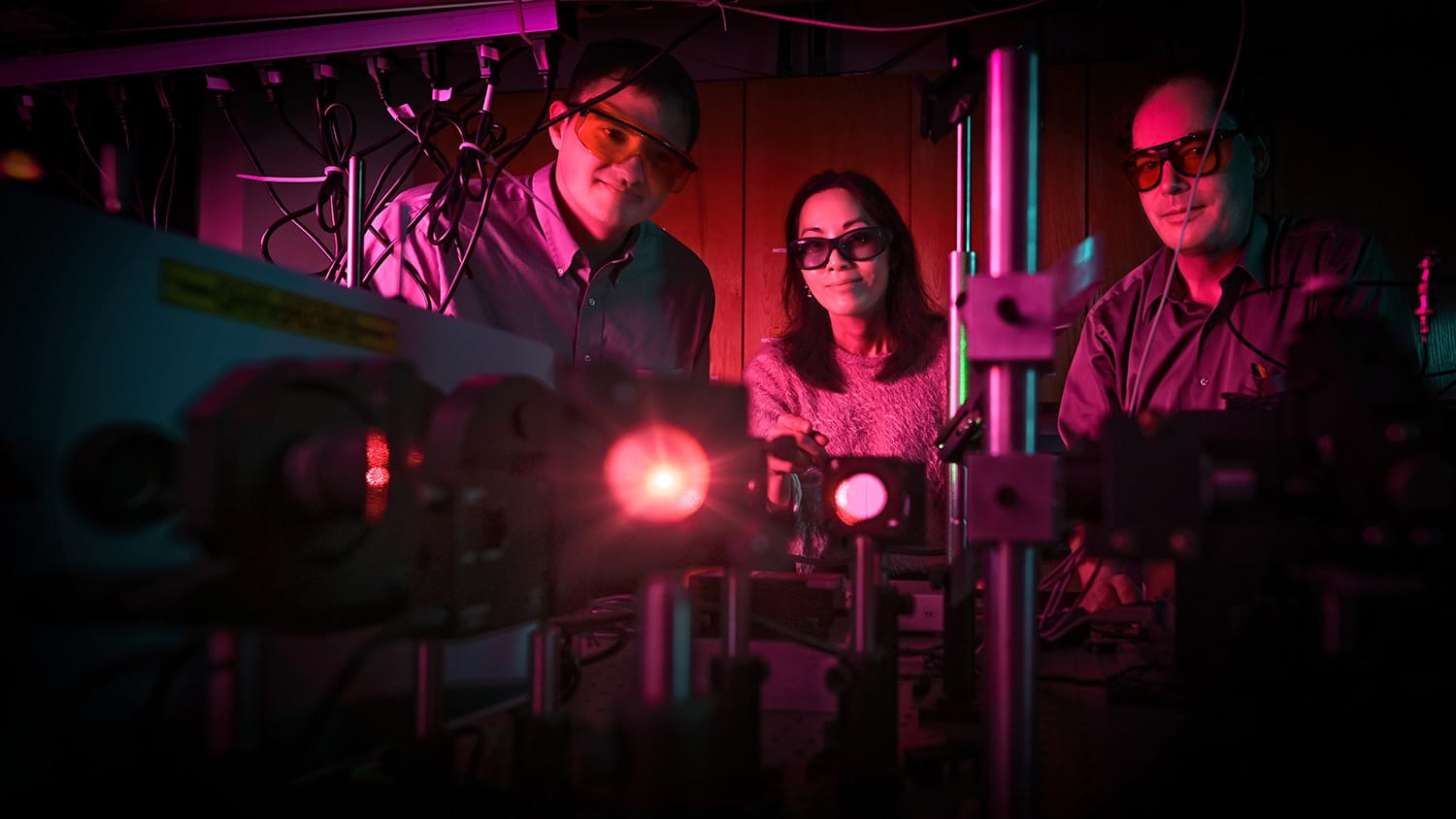 Kory Green, Shuang Fang Lim and Hans Hallen from the Department of Physics pictured in a laser lab