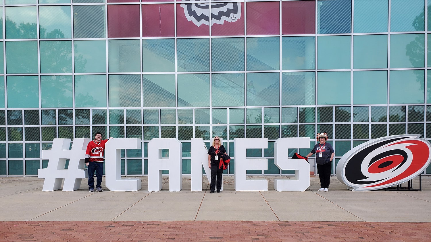 Corey Davis and family members stand in front of the PNC Arena in their Carolina Hurricanes gear