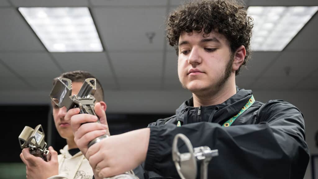 A Catalyst student works with robotics at a NASA facility