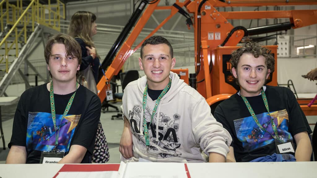 Three smiling Catalyst students pose at one of NASA's facilities