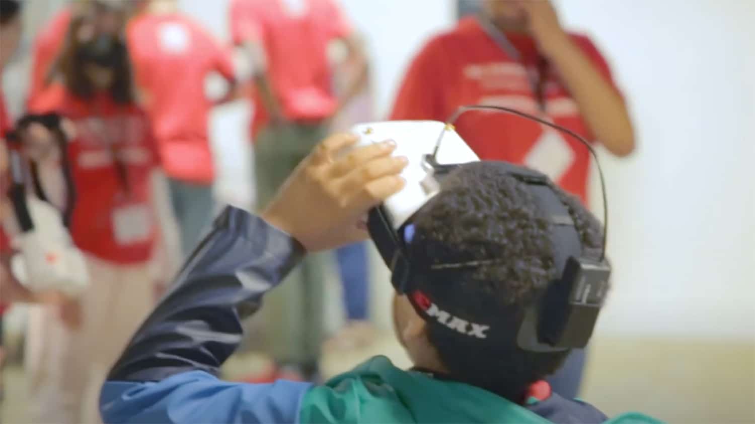 A young boy wears virtual reality goggles at an Imhotep Academy event