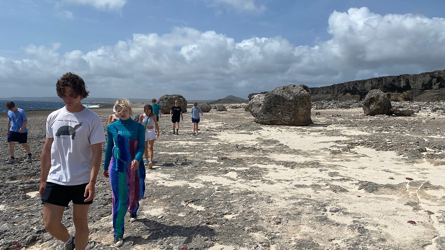 Students walk along the beach in Bonaire