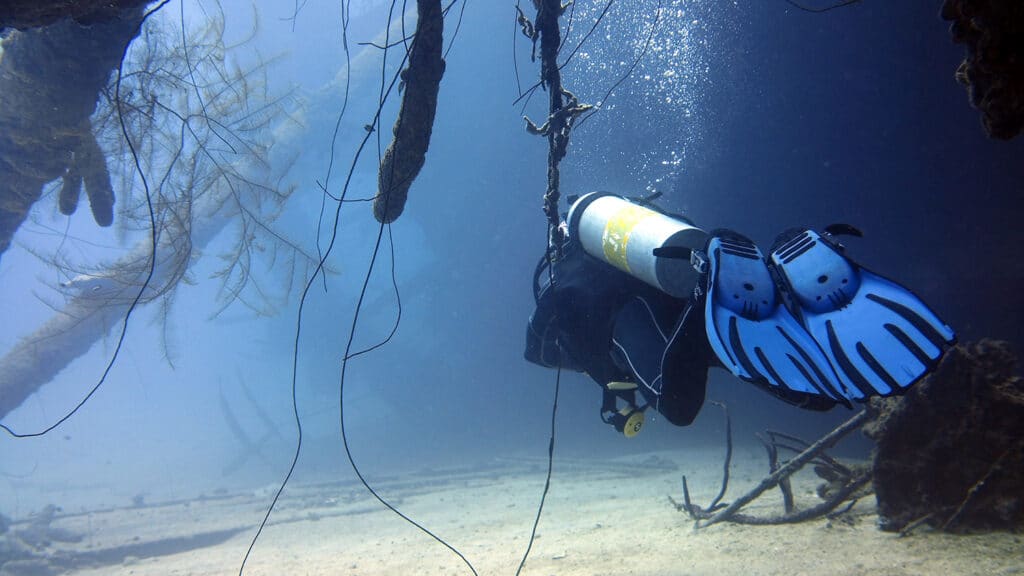 A scuba diver explores the Hilma Hooker shipwreck in Bonaire