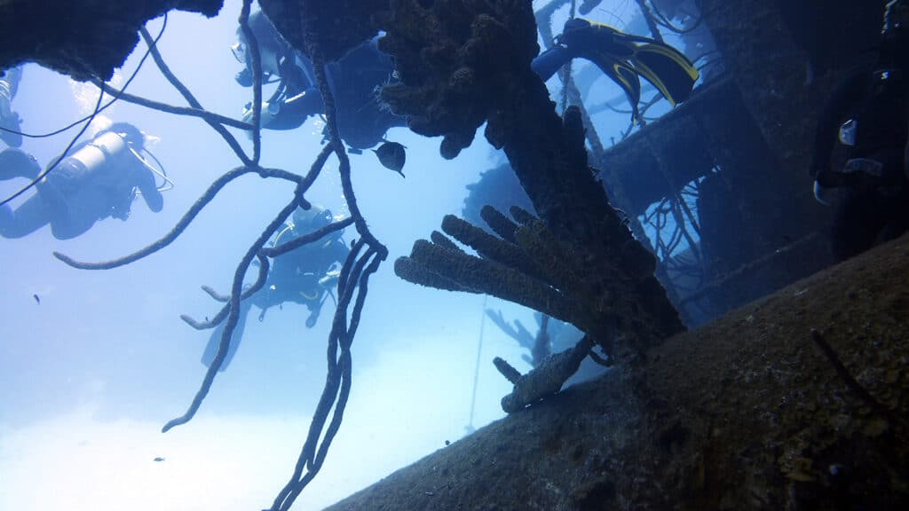 A group of scuba divers explore the Hilma Hooker shipwreck in Bonaire
