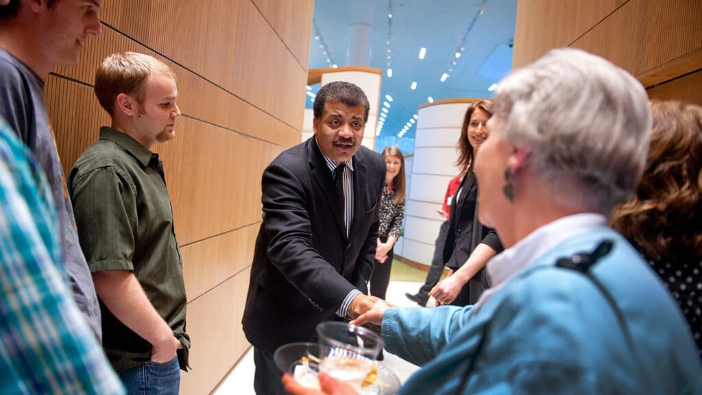 Neil deGrasse Tyson greets attendees at his 2014 talk at NC State