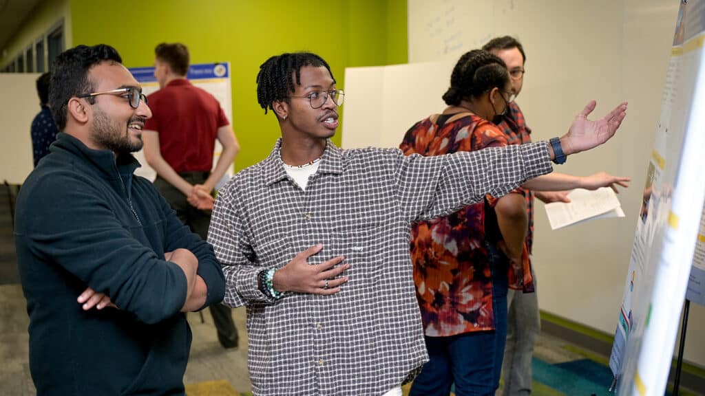 Wake Tech student Damien Johnson II presents his research at a poster session hosted by the Organic and Carbon Electronics Laboratory at NC State