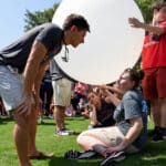 NC State’s Soundings Club prepares for a weather balloon launch during the 2017 solar eclipse viewing party on the Brickyard.