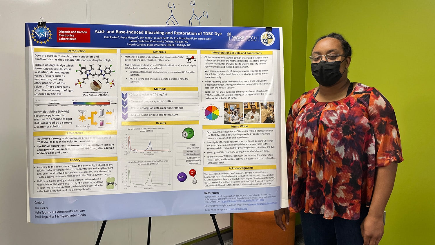 Wake Tech START student Kaia Parker stands beside her research poster
