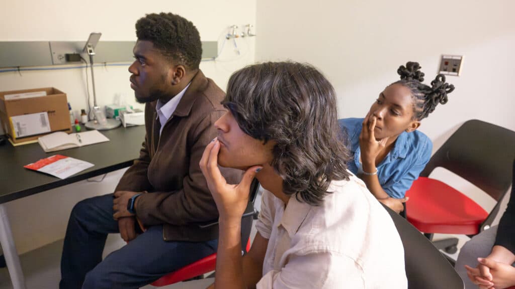 Students listen as Mariusz Zareba explains how to use the confocal microscope