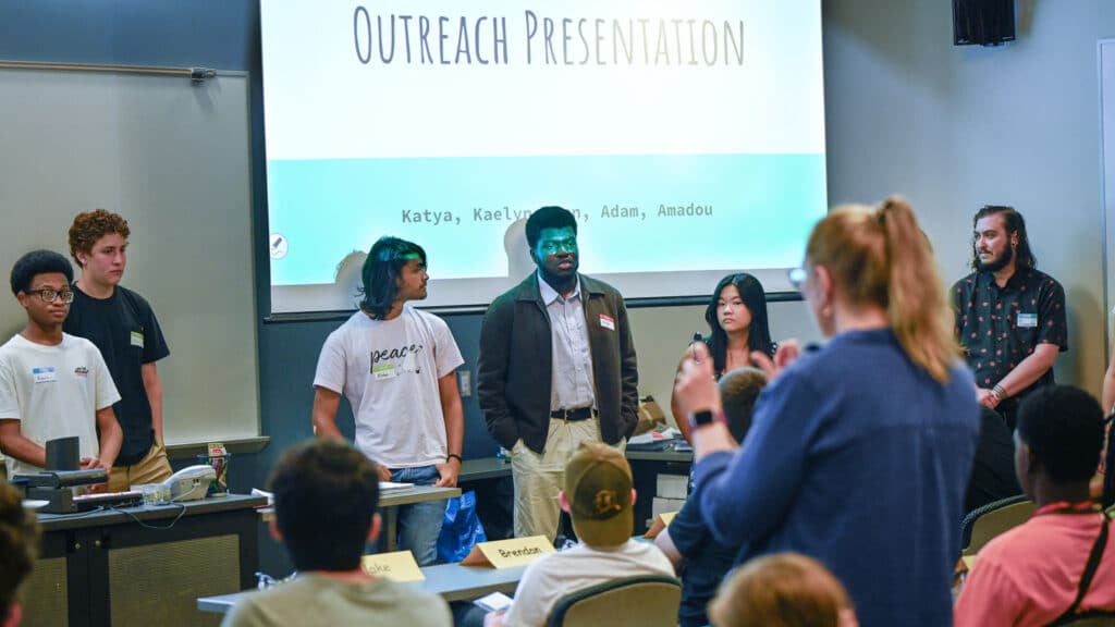 A group of students presenting in front of a class