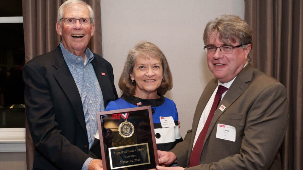 Dean Lewis Owen presents alumni Don and Pat Johnson with an award.