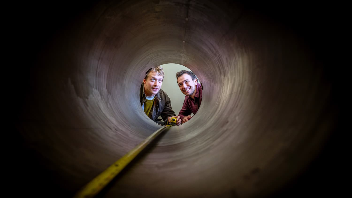 Graduate students Cole Teander and Clark Hickman with the stainless steel roundhouse they helped build.