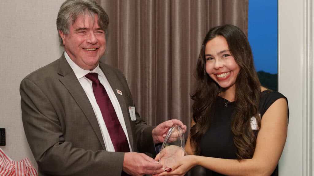 Dean Lewis Owen presents chemistry graduate student Juliana O'Brien with an award.