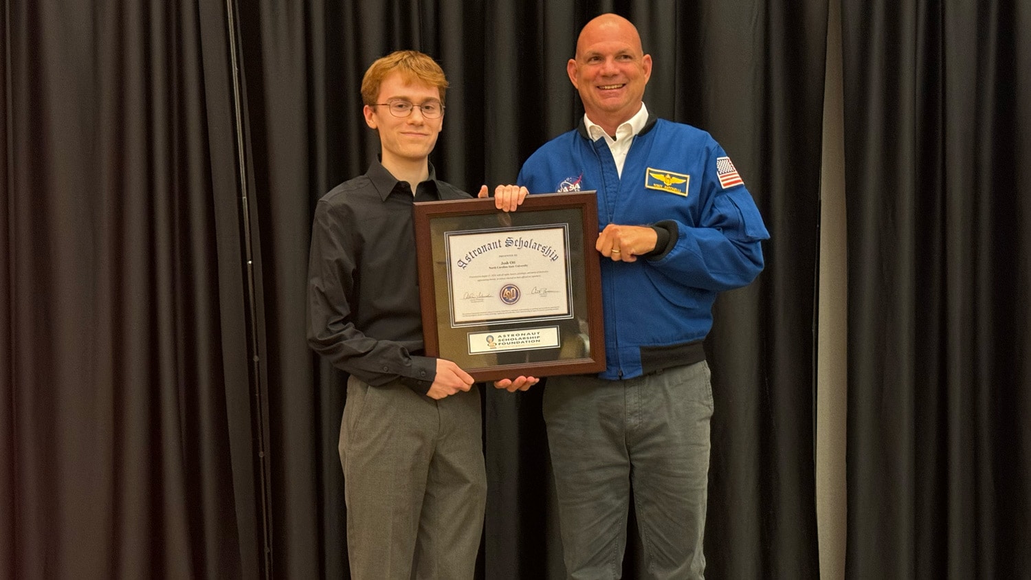 Veteran NASA Astronaut Tony Antonelli presents College of Sciences student Josh Ott with an Astronaut Scholarship award at NC State's Talley Student Union