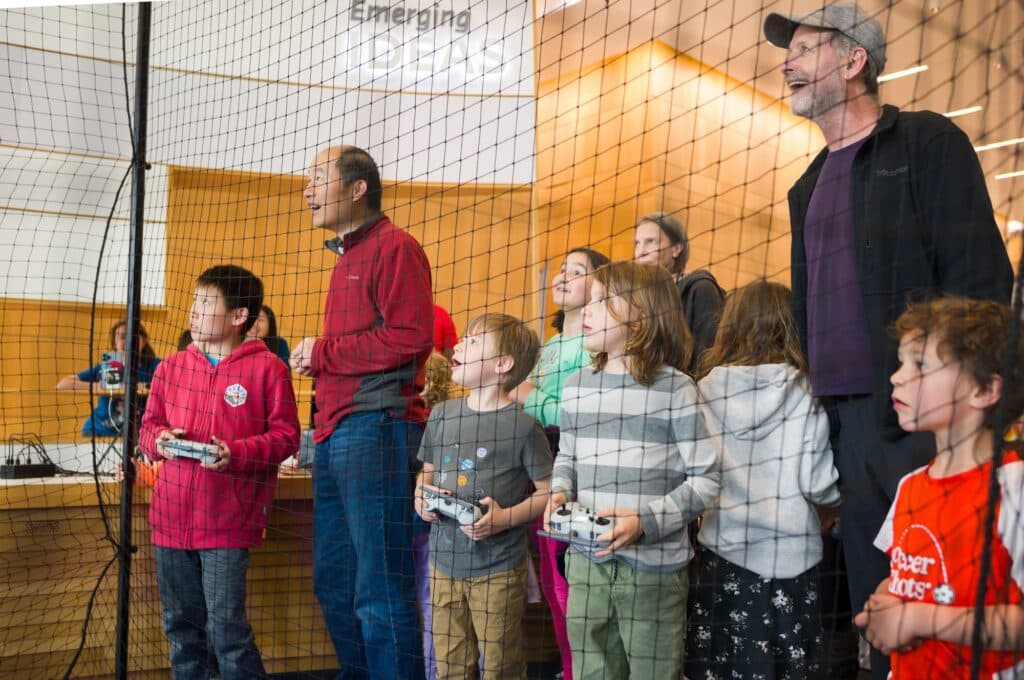 People standing next to netting