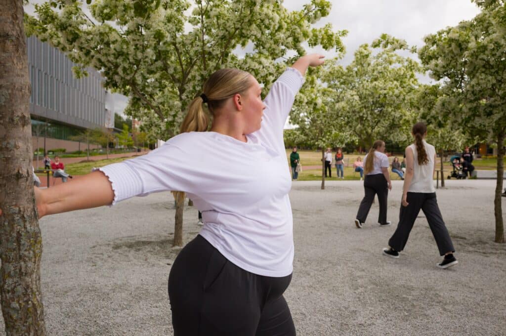A dancer in a white shirt