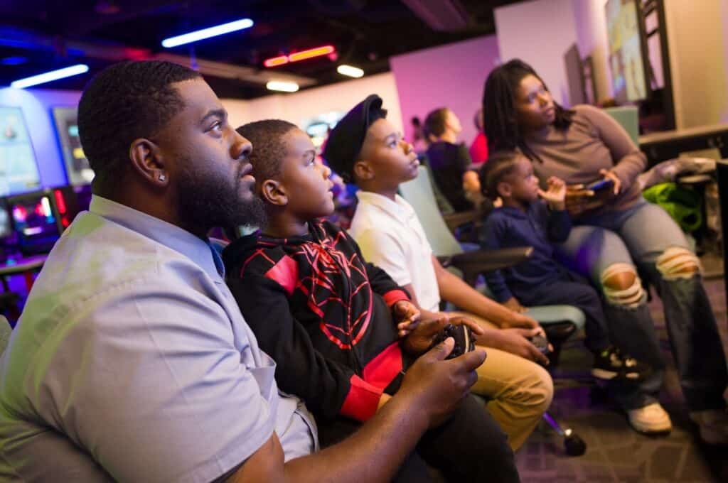 People sitting and a looking at a screen off-camera