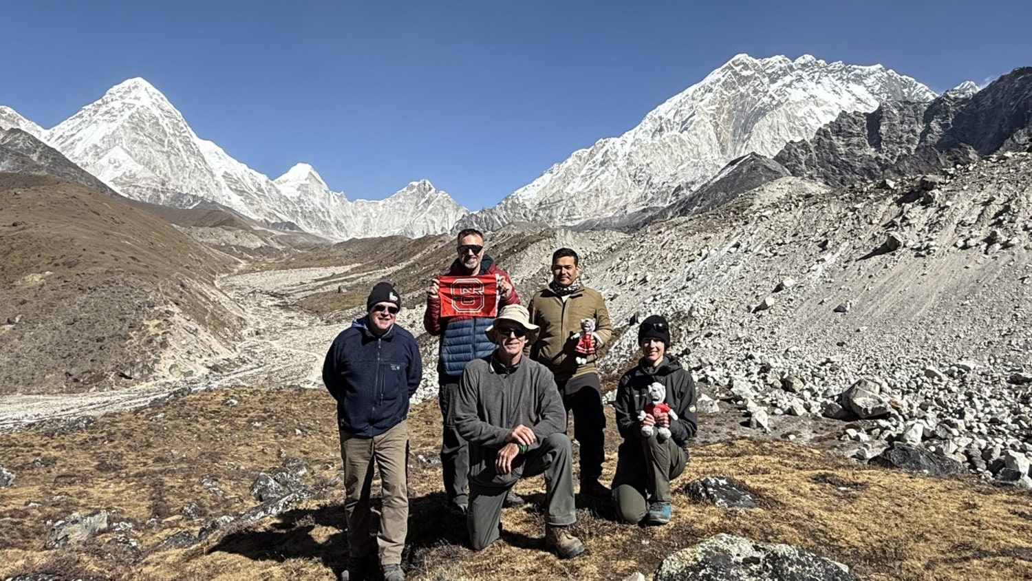 Lewis Owen, Karl Wegmann, Basant Bhandari, Jim Benton and Lucia Manatschal stand beside the Khumbu Glacier after eight days of hiking.