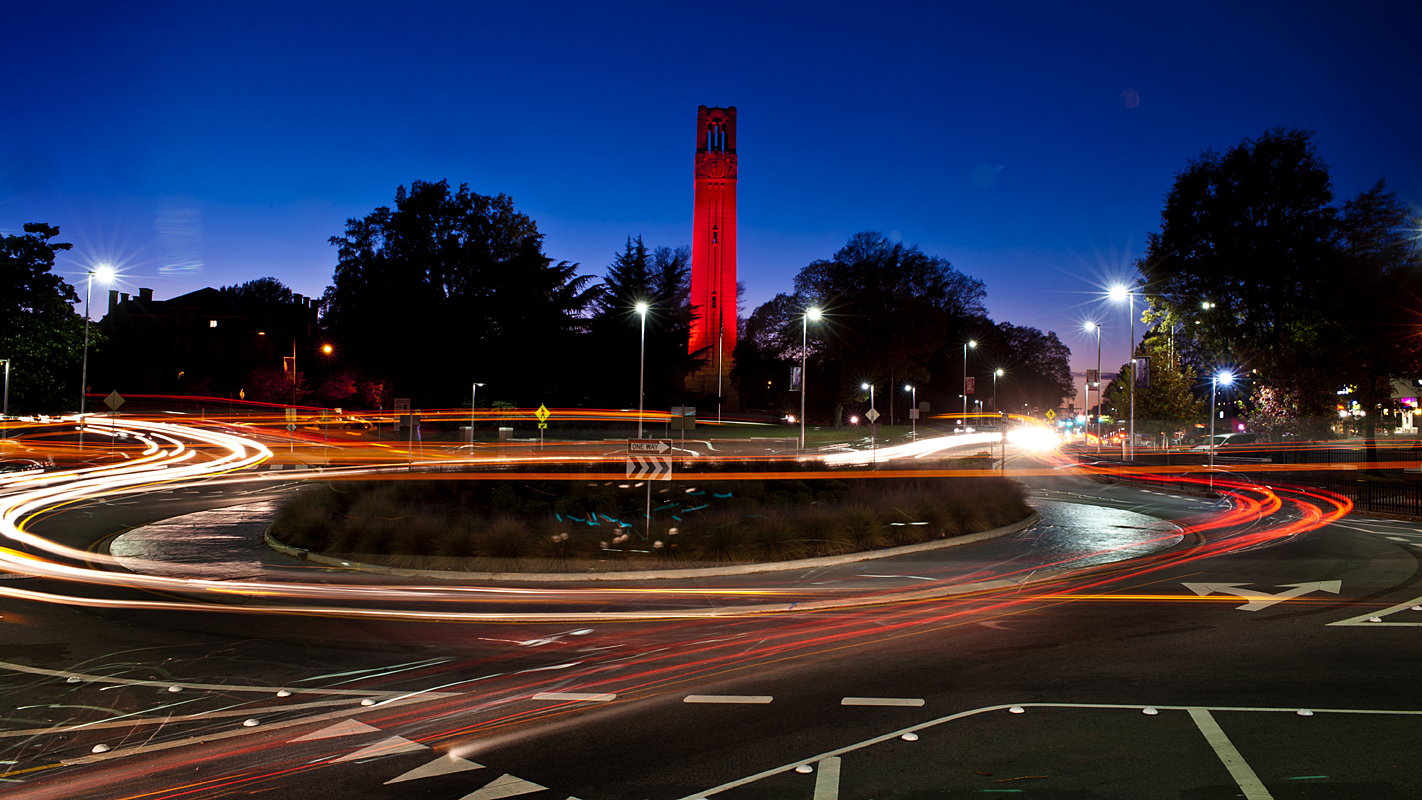 NC State Belltower lit red at night