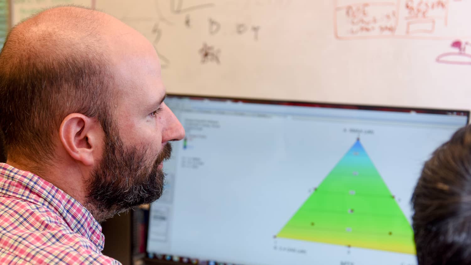 Michael Bereman in front of a computer screen with research data