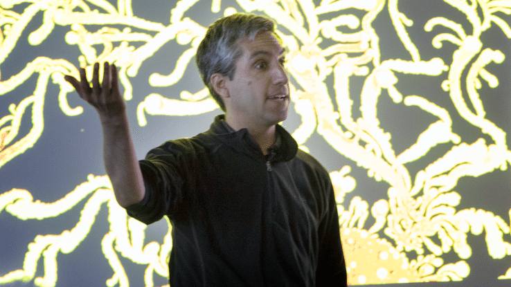 Carlos Goller presenting in front of a screen