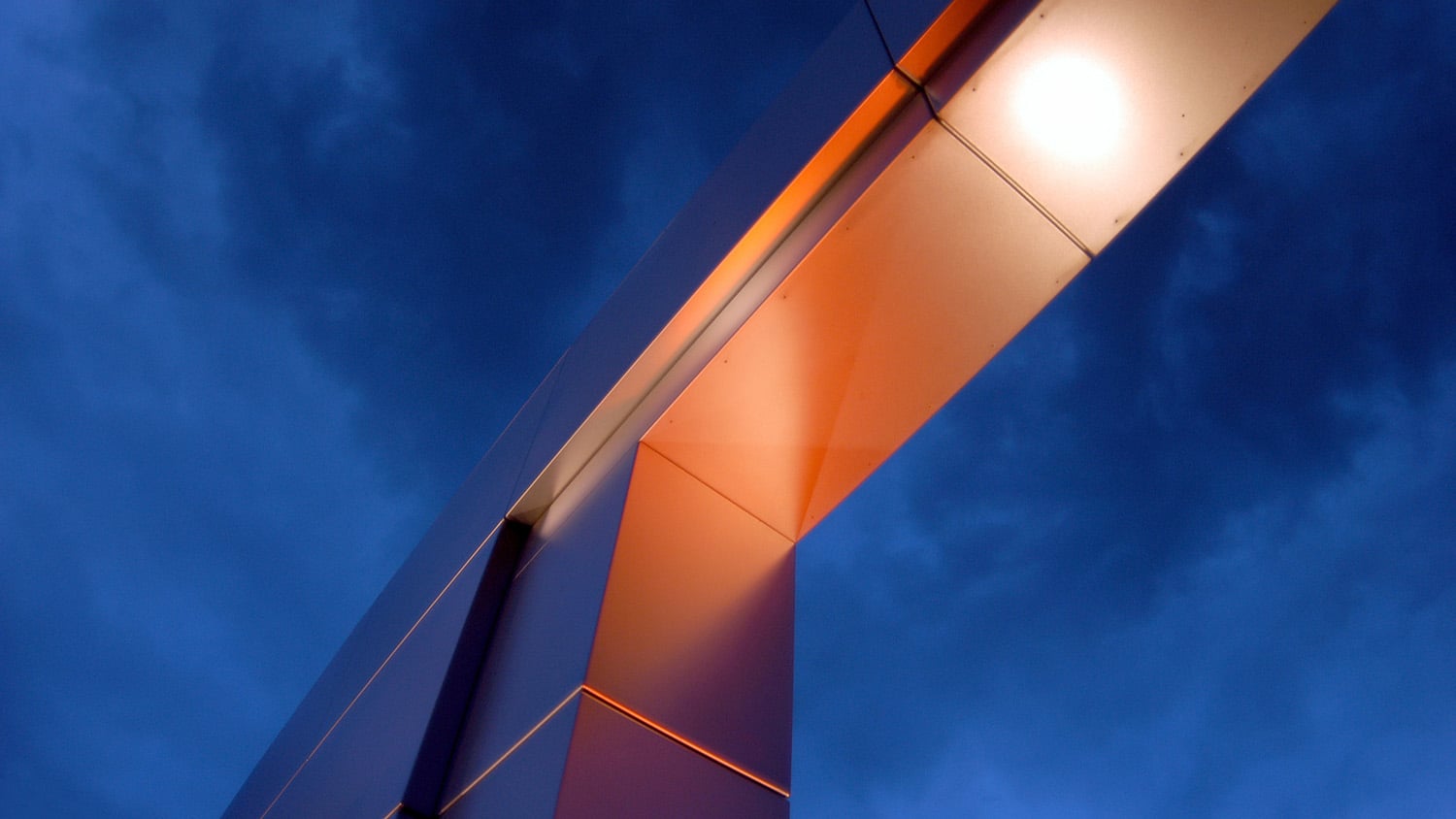 The campus gateway from underneath, against a blue sky