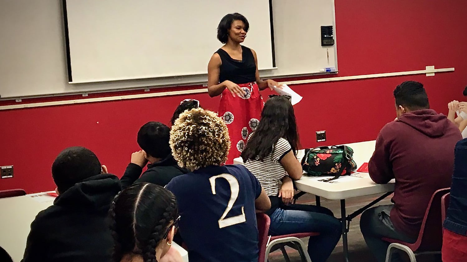 Pamela Gilchrist works with a group of students in a classroom